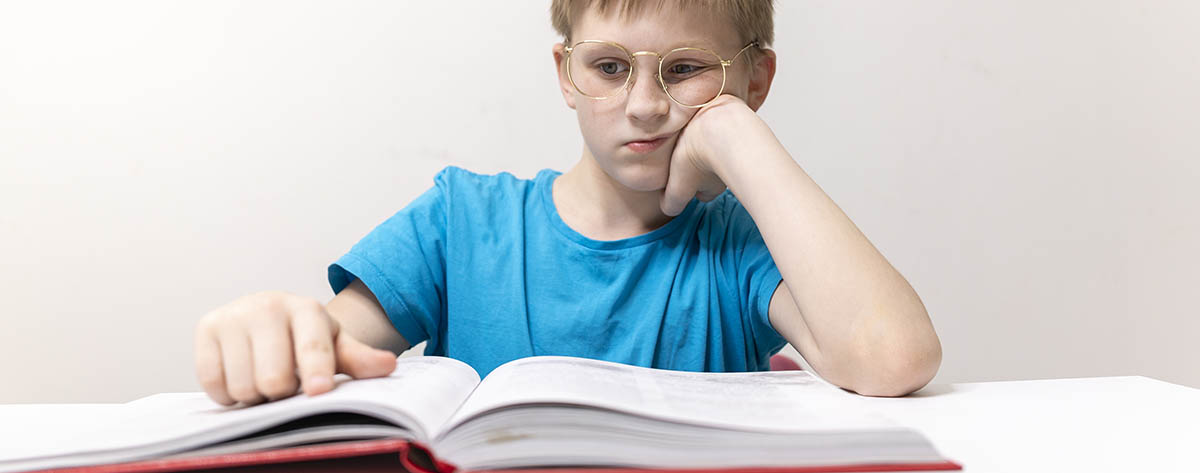 boy bored doing homework