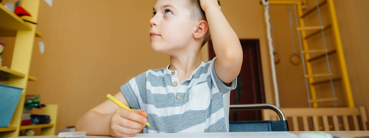 boy distracted doing homework