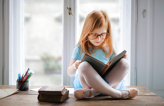 little girl reading a book