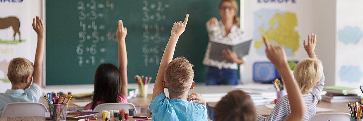 school children with their arm raise