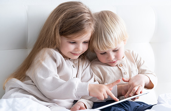 two cute kids with a tablet